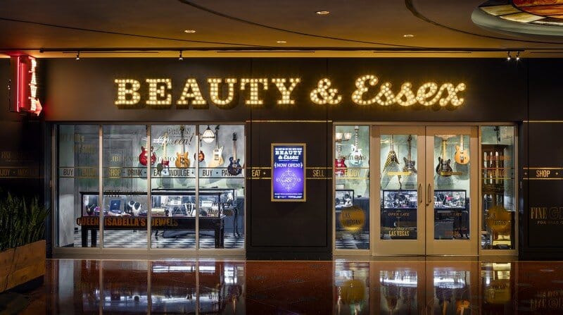 The illuminated Beauty & Essex entrance and pawnshop-style display windows at the Cosmopolitan.