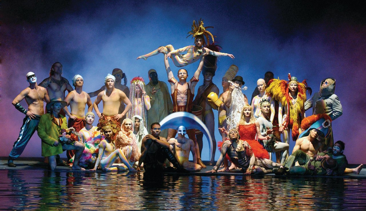 The cast of O at Bellagio gathered beside the water stage.