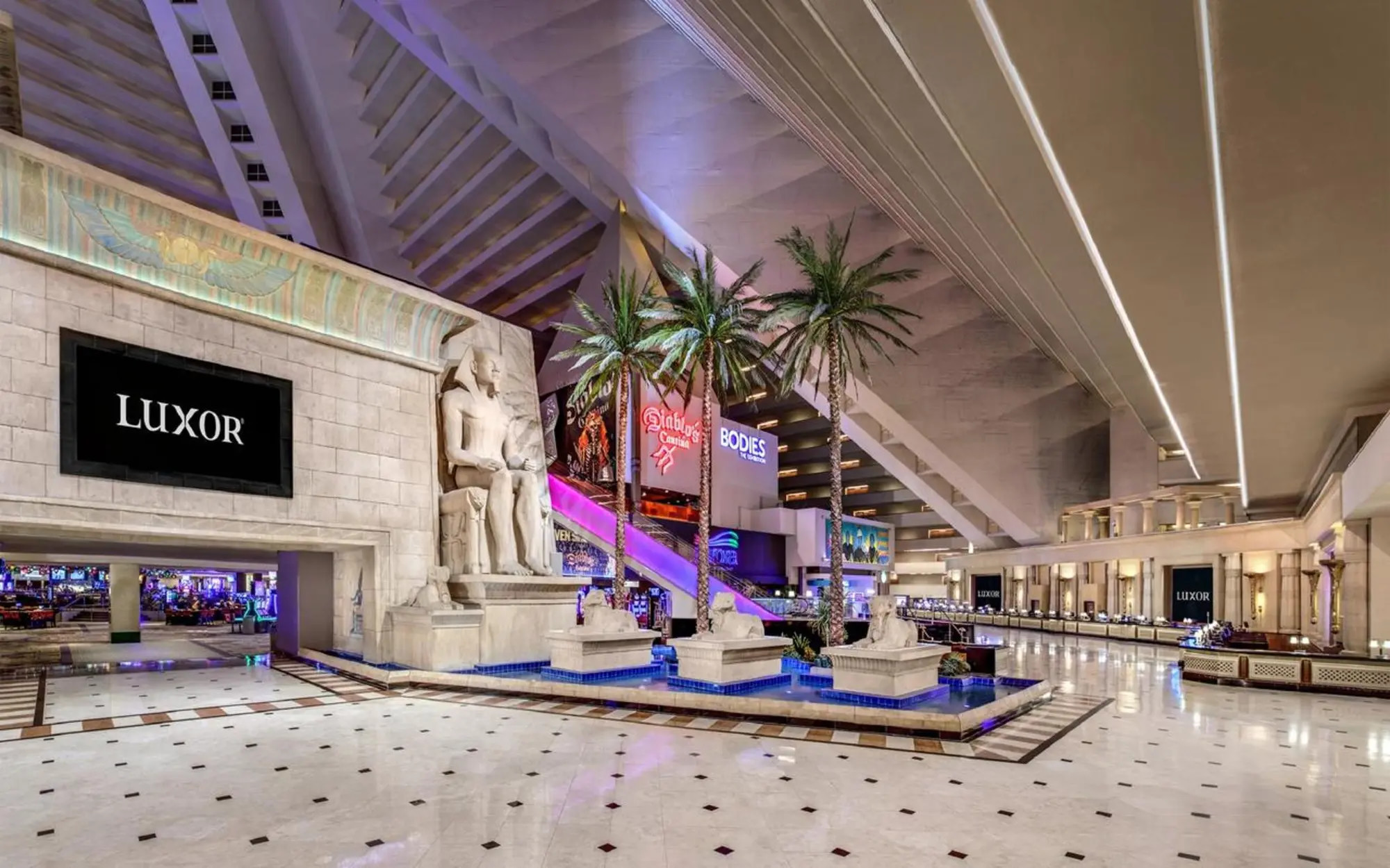 The Luxor atrium, with Egyptian-style statues, palms and a decorative pool.