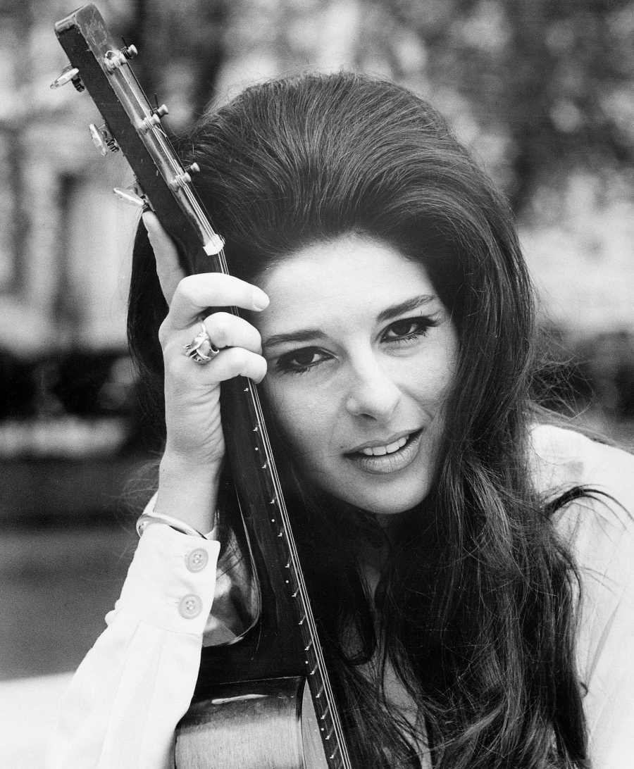 Bobbie Gentry holding an acoustic guitar in a black-and-white publicity portrait.