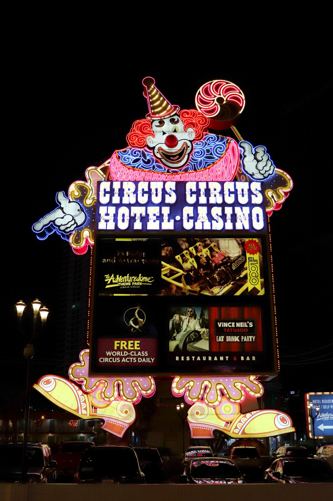 Lucky the Clown on the illuminated Circus Circus roadside sign at night.