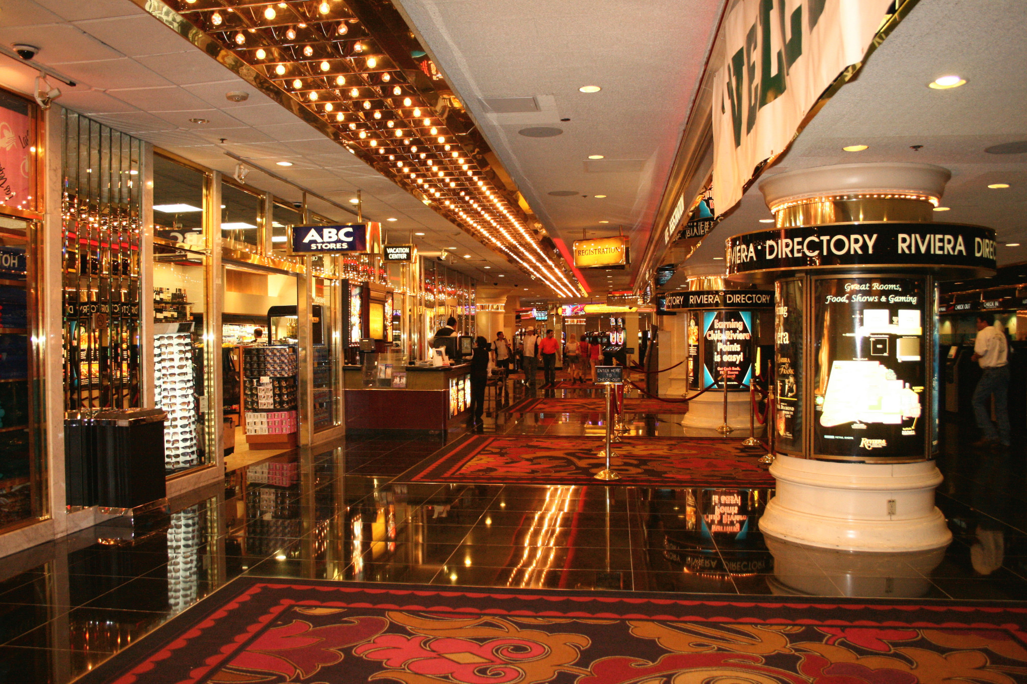The Riviera lobby, with illuminated directory columns, mirrored shopfronts and rows of ceiling lights.