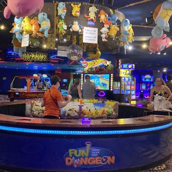 The Fun Dungeon arcade counter at Excalibur, with hanging plush prizes and game machines.