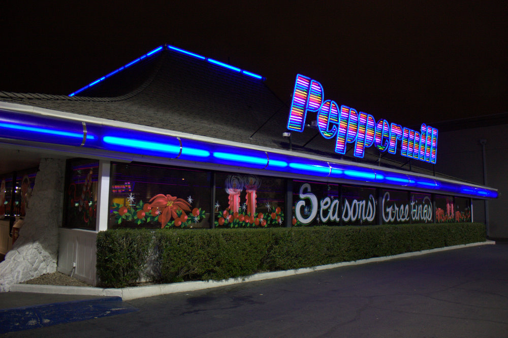 Peppermill neon roof sign and low restaurant frontage at night in January 2011.