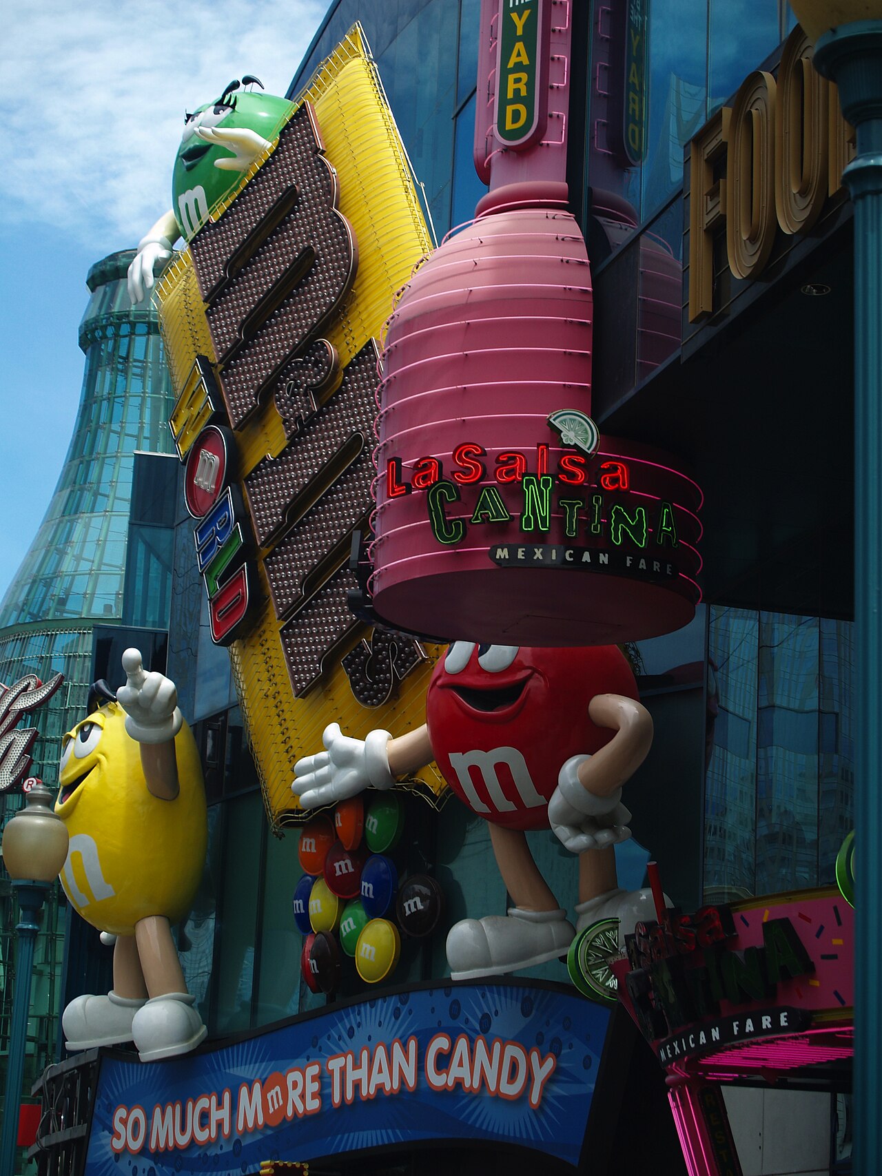 M&M characters beside the store’s illuminated sign.