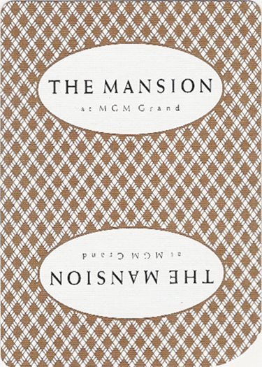 Brown-and-white patterned playing-card back reading The Mansion at MGM Grand.