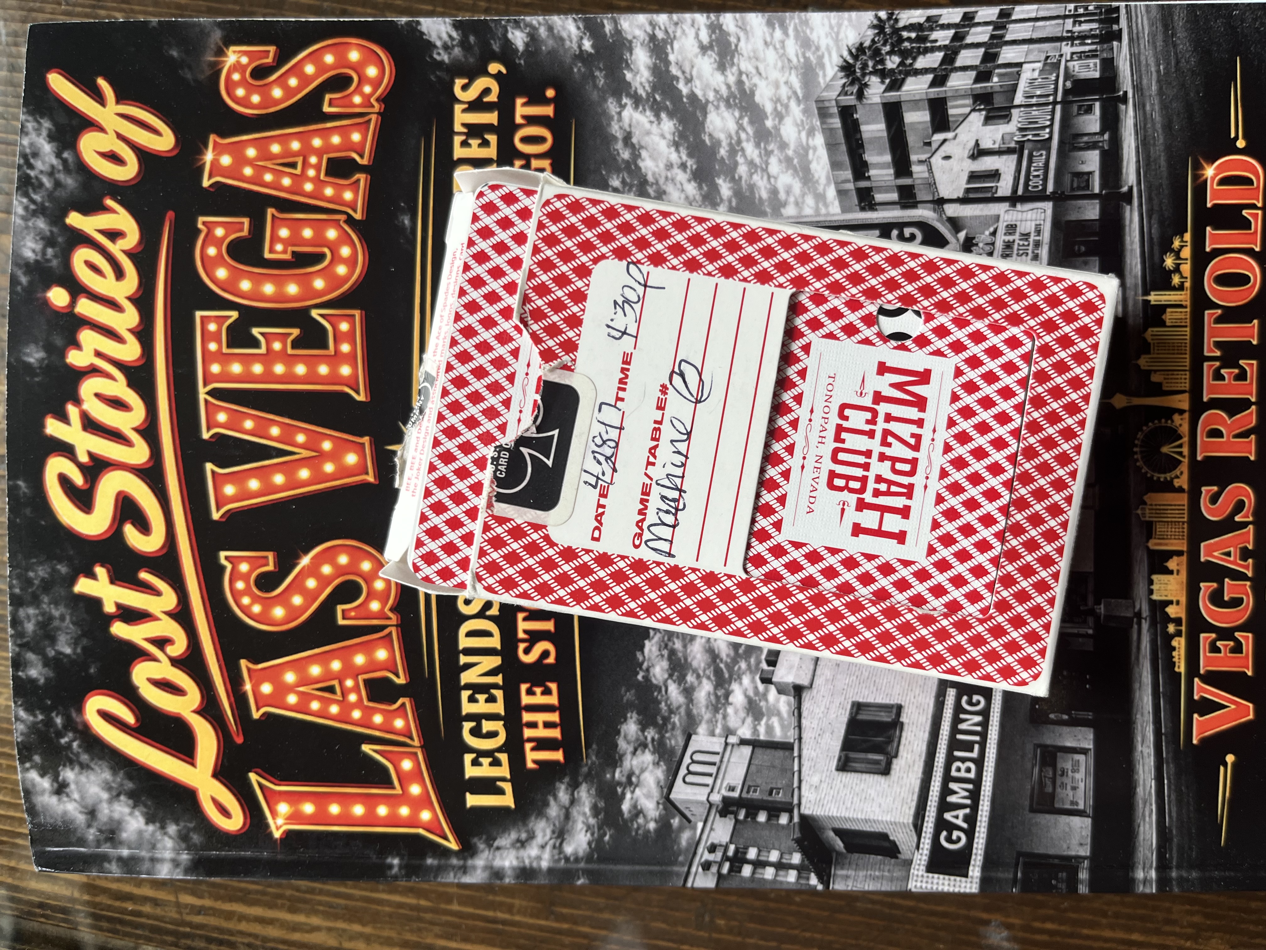 Red-and-white Mizpah Club deck box with a handwritten date, time and machine notation.