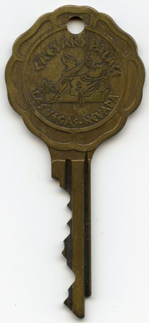 Brass-coloured Caesars Palace key with a large scalloped bow.