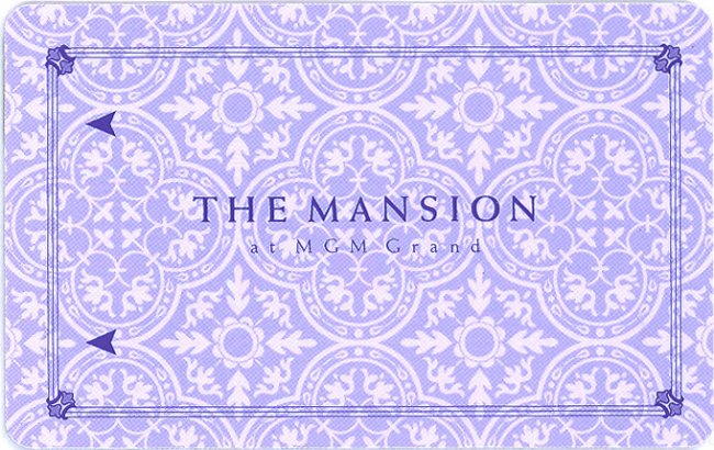 Lavender patterned keycard bearing The Mansion at MGM Grand name and two dark arrows.