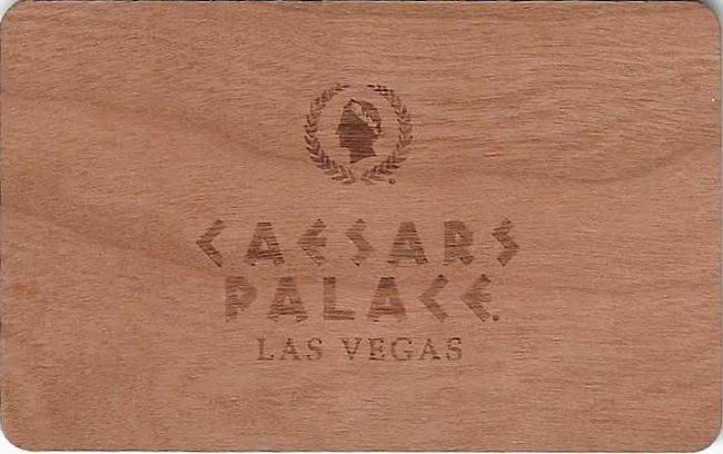 Wood-grain-look Caesars Palace keycard with the hotel name and a profile emblem.