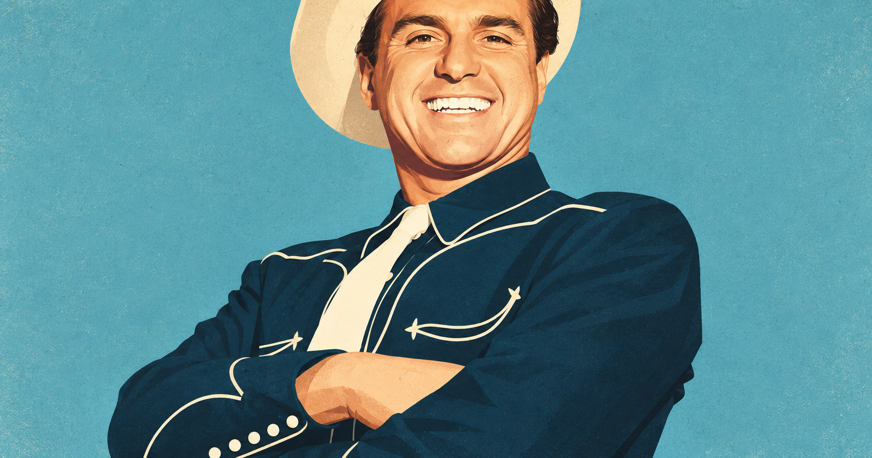 Stan Irwin smiles with his arms crossed, wearing a cowboy hat and a dark Western shirt with cream piping.