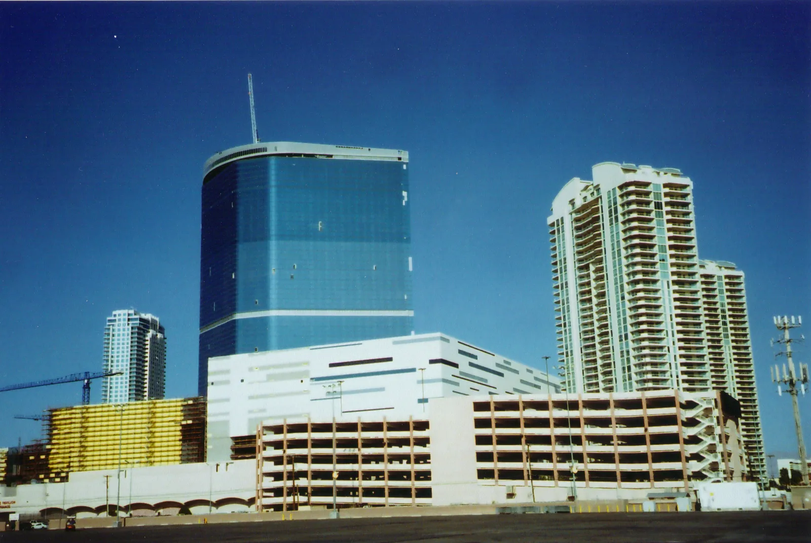 The blue Fontainebleau tower under construction in 2009, behind a separate parking garage and beside white condominium towers, shown as later-site context for the demolished El Rancho.