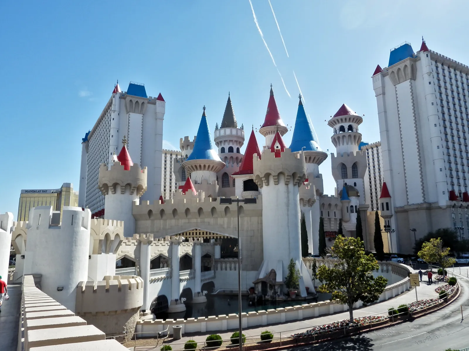 Excalibur’s white castle walls, colorful turrets and hotel towers in 2018, with a separate gold Mandalay Bay tower at far left.