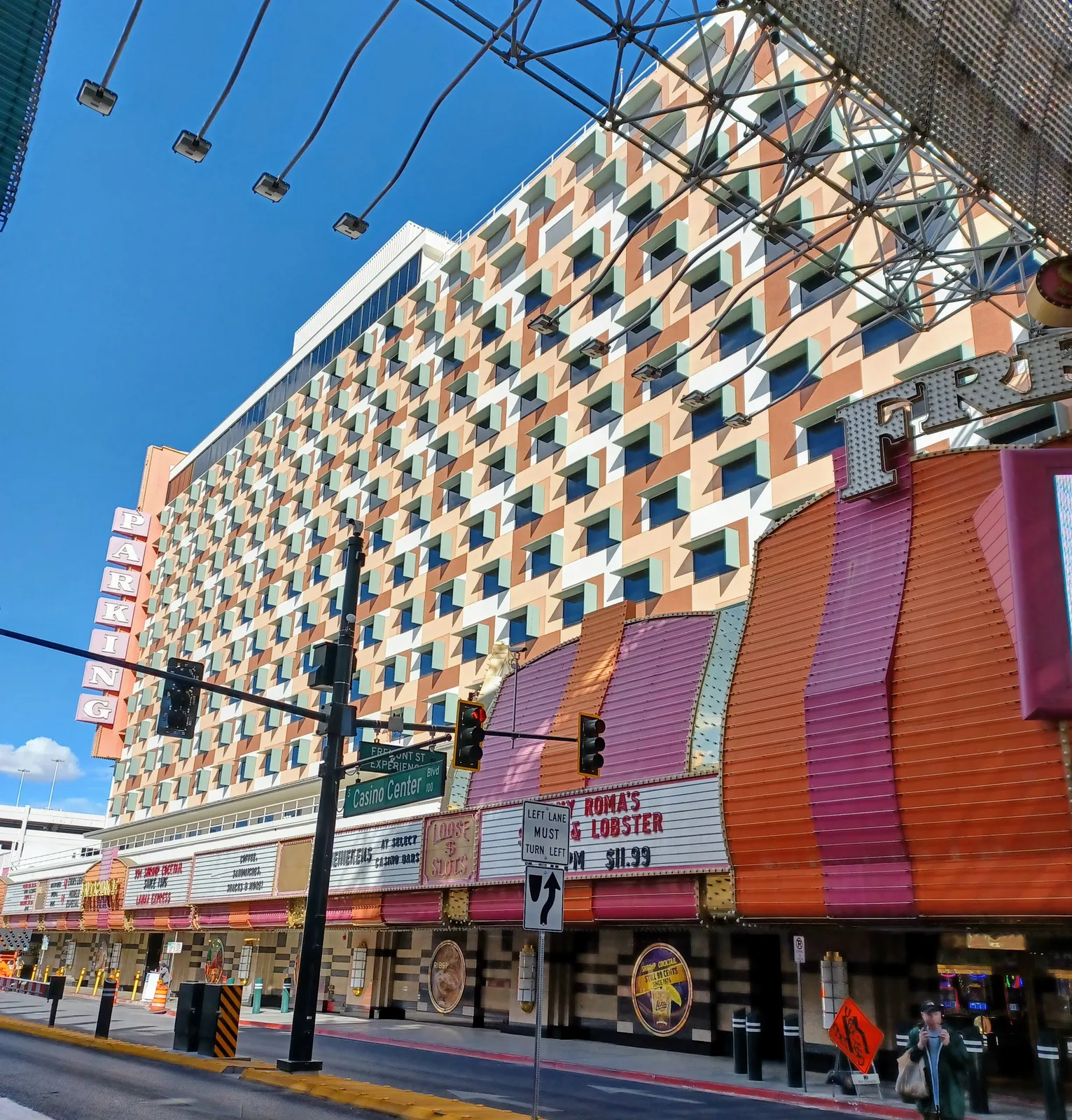 The Fremont’s patterned hotel facade and colorful casino frontage beneath the overhead Fremont Street canopy structure.