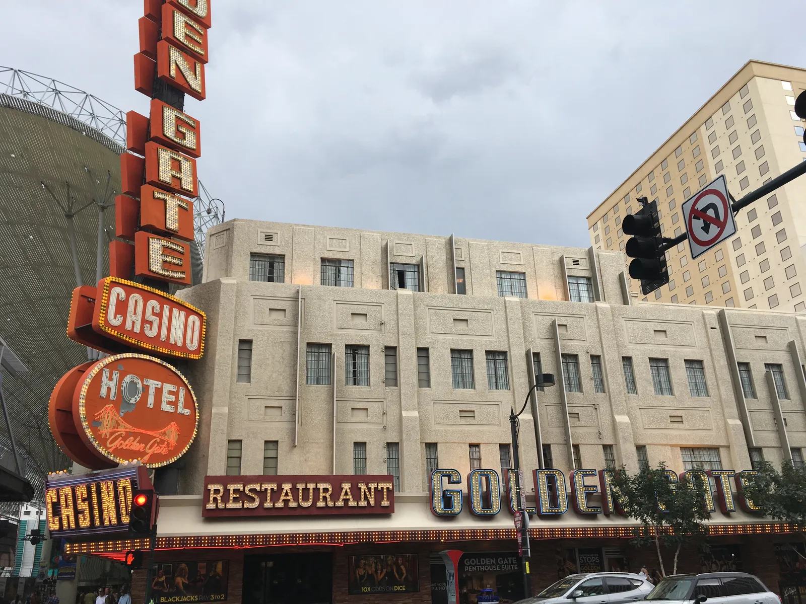 Golden Gate’s pale three-story frontage, red vertical hotel and casino sign and illuminated lettering on Fremont Street.