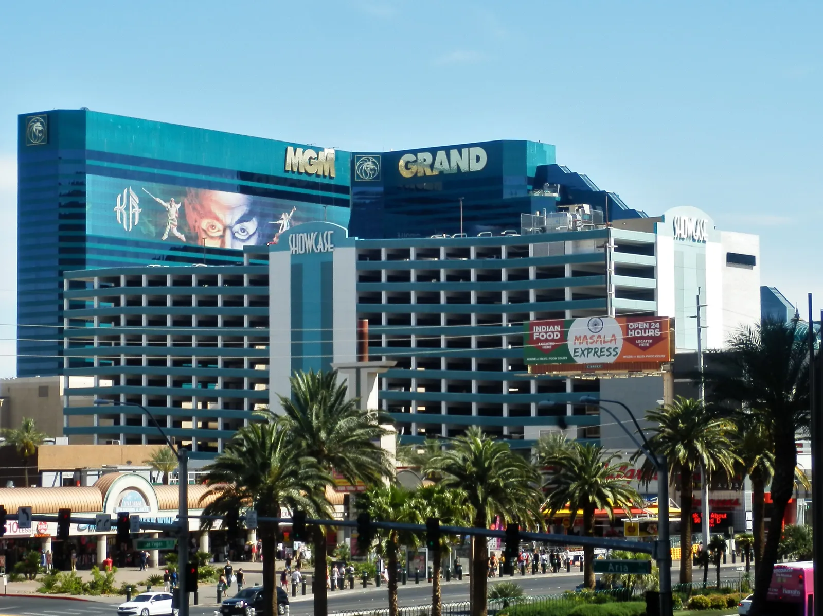 Green MGM Grand hotel towers and their rooftop name in 2018, with a separate Showcase parking garage in front.