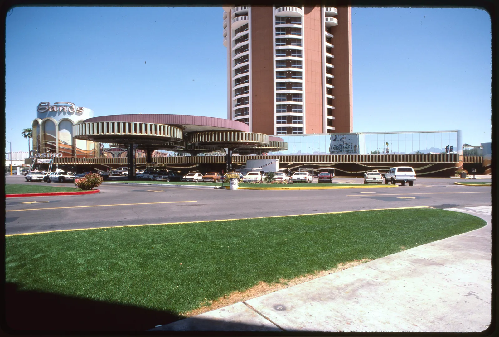 The Sands entrance canopy and sign beside its tall hotel tower, seen across the street.