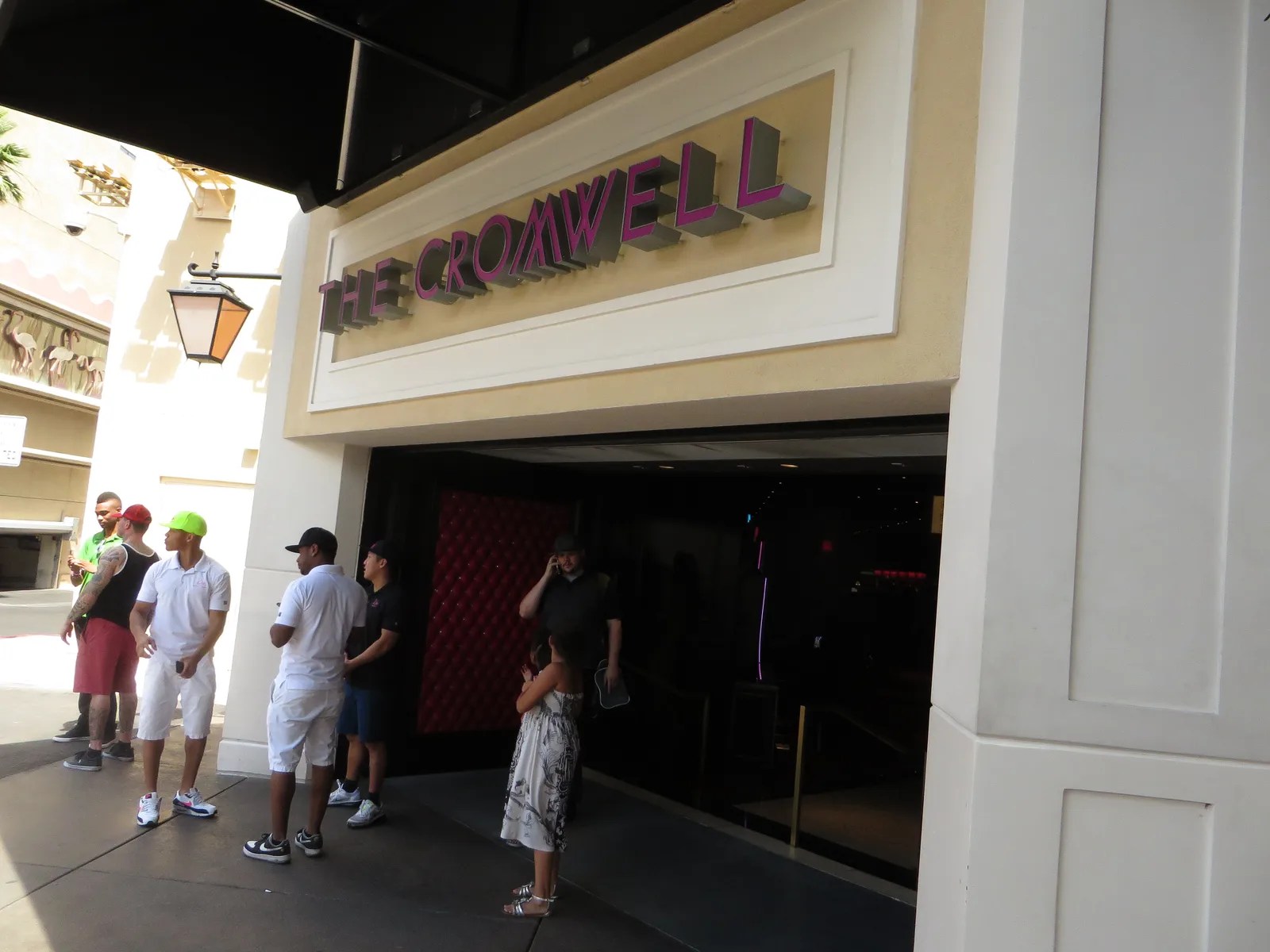 The Cromwell name above its entrance in June 2015, with people outside and part of the neighboring Flamingo sign at left.
